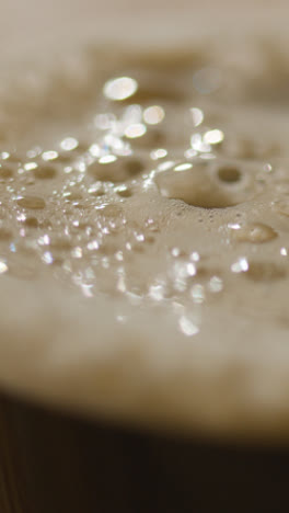 Vertical-Video-Close-Up-Of-Pint-Of-Irish-Stout-In-Glass-To-Celebrate-St-Patricks-Day-2